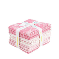 Stack of pink and white fabric bundles tied with a white ribbon on a white background